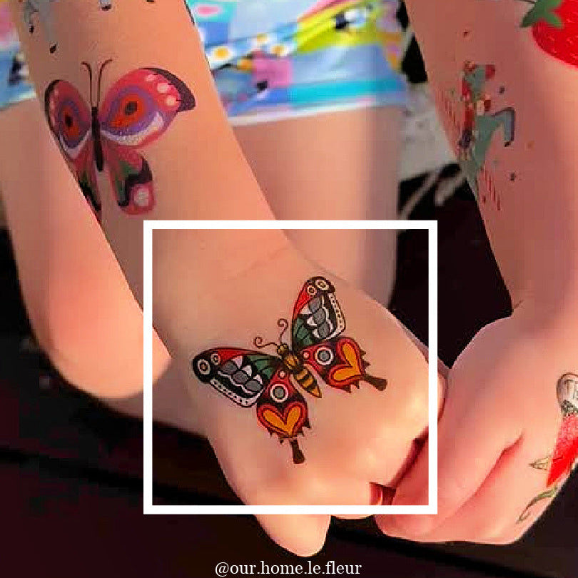 Colorful butterfly temporary tattoo on a young girl's arm.