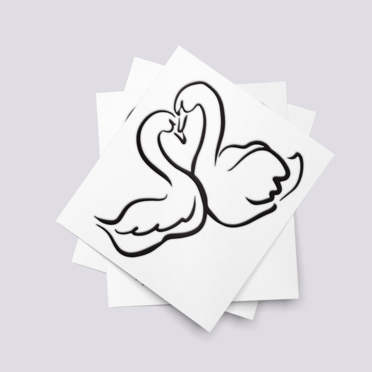 Temporary tattoo of two swans who form the shape of a heart for wedding.