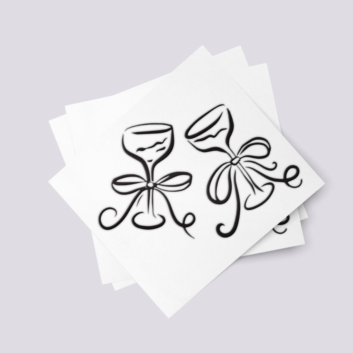 Temporary tattoo of wine glasses decorated with ribbons for wedding.