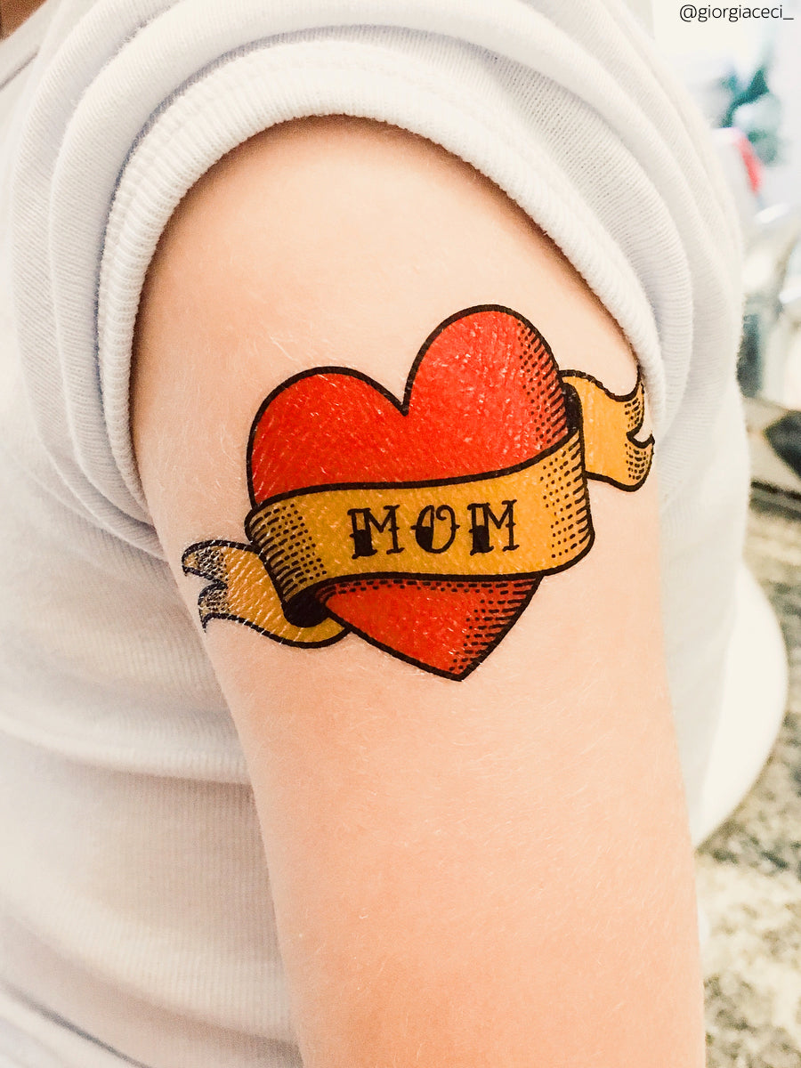 A tattoo with the inscription of Mom. A heart and flower tattoo with a  flower. Tattoo in the style of the American old school. Vector flat tattoo.  The Stock Vector Image &