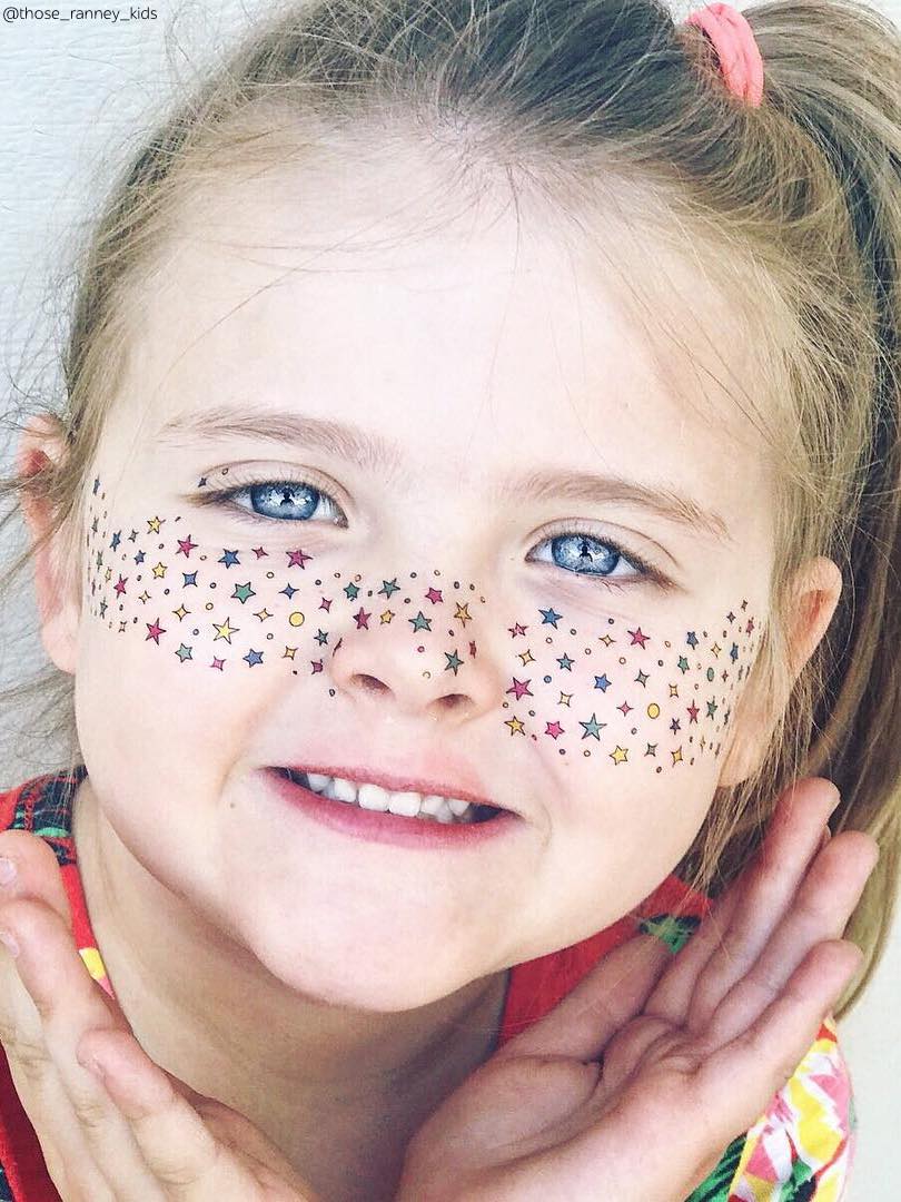 Girl with temporary freckles temporary tattoos. Rainbow stars freckles for party.